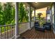 Enjoy outdoor living on this back porch featuring white columns and comfortable seating at 1423 Tannin Dr, Durham, NC 27713