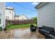 Cozy backyard patio with outdoor seating, string lights, and a well-maintained lawn and fence at 1423 Tannin Dr, Durham, NC 27713