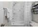 Stylish bathroom features white marble tiled walls, a shower and tub, and modern fixtures at 1423 Tannin Dr, Durham, NC 27713