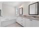 Bathroom featuring double vanity, granite countertop, a soaking tub, and neutral color palette at 1423 Tannin Dr, Durham, NC 27713