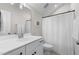 Bright bathroom featuring a vanity, framed mirror, and a shower-tub with white shower curtain at 1423 Tannin Dr, Durham, NC 27713