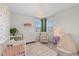 Adorable Bedroom with charming wallpaper, a white crib, and a cozy reading nook at 1423 Tannin Dr, Durham, NC 27713