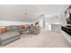 Bright bonus room with a comfortable gray sectional sofa and ample natural light at 1423 Tannin Dr, Durham, NC 27713