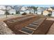 Developing community garden with organized plots and fresh mulch at 1423 Tannin Dr, Durham, NC 27713