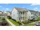 Two-story home with double porches and manicured lawn located on a tree-lined street at 1423 Tannin Dr, Durham, NC 27713