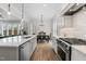 Open kitchen features white cabinets, stainless appliances, stone countertops, and adjacent dining area at 1423 Tannin Dr, Durham, NC 27713
