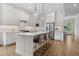 Modern kitchen with white cabinets, stainless steel appliances, and a spacious island with bar seating at 1423 Tannin Dr, Durham, NC 27713