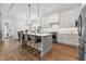 Spacious kitchen with stainless steel appliances, a center island, and adjacent dining area at 1423 Tannin Dr, Durham, NC 27713