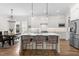 Open-concept kitchen featuring a large island, pendant lighting, and hardwood flooring at 1423 Tannin Dr, Durham, NC 27713