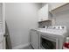 Bright laundry room with white cabinets and modern washer and dryer set at 1423 Tannin Dr, Durham, NC 27713