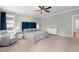 This main bedroom features plush carpeting, a ceiling fan, and a luxurious blue headboard at 1423 Tannin Dr, Durham, NC 27713