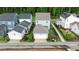 Aerial view of home showcasing the rear exterior, fenced yard, and attached garage at 1423 Tannin Dr, Durham, NC 27713