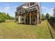 Backyard view of two-story home with deck and staircase at 1458 Wragby Ln, Apex, NC 27502