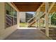 View of outdoor covered patio below wooden deck and staircase at 1458 Wragby Ln, Apex, NC 27502