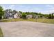 Community basketball court provides outdoor recreation near neighborhood homes surrounded by trees and blue skies at 1458 Wragby Ln, Apex, NC 27502