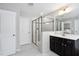 This bathroom features a glass enclosed shower, a modern vanity, and neutral tile flooring at 1458 Wragby Ln, Apex, NC 27502