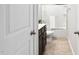 Half view of a bathroom with dark vanity, tub-shower, and light tile floor at 1458 Wragby Ln, Apex, NC 27502