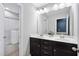 Bathroom with double vanity, white countertop, and a shower over tub combo in the background at 1458 Wragby Ln, Apex, NC 27502