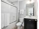 Standard bathroom with shower-tub combination, dark vanity, and tile floor at 1458 Wragby Ln, Apex, NC 27502