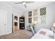 Bedroom with bookshelf, art wall, and desk area, doorway to kitchen visible at 1458 Wragby Ln, Apex, NC 27502