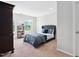 Bedroom featuring a upholstered bed frame, neutral carpet, and natural light from the windows at 1458 Wragby Ln, Apex, NC 27502