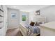 Charming bedroom with a white bed frame, artwork, two windows, and carpeted floors at 1458 Wragby Ln, Apex, NC 27502
