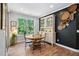 Charming dining room with plenty of natural light and dark accent wall at 1458 Wragby Ln, Apex, NC 27502
