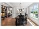 Elegant dining room with hardwood floors, chandelier, and natural light at 1458 Wragby Ln, Apex, NC 27502