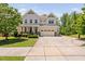 Charming two-story home featuring a manicured lawn, attached two-car garage, and inviting front porch at 1458 Wragby Ln, Apex, NC 27502