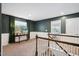 Upstairs hallway with decorative wainscotting and view to the living room at 1458 Wragby Ln, Apex, NC 27502