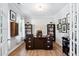 Home office with hardwood floors, large desk, and built-in bookshelves at 1458 Wragby Ln, Apex, NC 27502