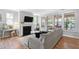 Comfortable living room with fireplace, ample natural light, and hardwood floors at 1458 Wragby Ln, Apex, NC 27502