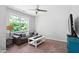 Living room featuring a sofa, coffee table, ceiling fan, and a bright window at 1458 Wragby Ln, Apex, NC 27502
