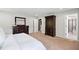 Spacious main bedroom with a mirror, dresser, and a glimpse of an adjoining bathroom at 1458 Wragby Ln, Apex, NC 27502