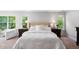 Bright main bedroom with windows, plush bed, and stylish bedside tables with lamps at 1458 Wragby Ln, Apex, NC 27502