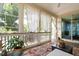 Cozy screened-in porch with plenty of natural light and views of yard at 1458 Wragby Ln, Apex, NC 27502