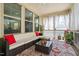Cozy sunroom with large windows, comfortable seating, and stylish decor at 1458 Wragby Ln, Apex, NC 27502