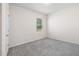 Bright bedroom features neutral walls, plush gray carpet, and a window view at 1512 Arapahoe Ridge Dr, Raleigh, NC 27604