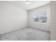 Bright bedroom features neutral walls, plush gray carpet, and a sunlit window at 1512 Arapahoe Ridge Dr, Raleigh, NC 27604