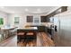 Modern kitchen with an island, stainless steel appliances, and a dining area with hardwood floors at 1512 Arapahoe Ridge Dr, Raleigh, NC 27604