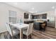 Modern kitchen with stainless steel appliances, a central island, and an adjacent dining area at 1512 Arapahoe Ridge Dr, Raleigh, NC 27604