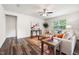 Bright living room features hardwood floors, a ceiling fan and natural light from the window at 1512 Arapahoe Ridge Dr, Raleigh, NC 27604