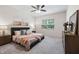 Comfortable main bedroom with neutral tones, ceiling fan, and plenty of natural light at 1512 Arapahoe Ridge Dr, Raleigh, NC 27604