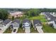 Modern home exteriors with attached garages and well-kept lawns in a neighborhood with nearby construction, nestled among trees at 159 Wood Orchid Ln, Garner, NC 27529