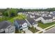 New construction homes showcase manicured lawns and modern facades in a desirable community setting, surrounded by mature trees at 159 Wood Orchid Ln, Garner, NC 27529