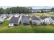 Aerial view of a serene neighborhood featuring homes with lush green backyards and screened-in porches at 159 Wood Orchid Ln, Garner, NC 27529