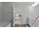 View of a well-lit bathroom leading into a bedroom, showcasing a bathtub and modern fixtures at 159 Wood Orchid Ln, Garner, NC 27529