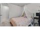 Cozy bedroom with a comfortable bed, whimsical canopy, and a view of the hallway at 159 Wood Orchid Ln, Garner, NC 27529