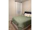 Comfortable bedroom with a green bedspread, soft carpet, and neutral walls at 159 Wood Orchid Ln, Garner, NC 27529