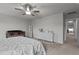 Well-lit bedroom with neutral walls featuring a cozy crib and dresser for baby care at 159 Wood Orchid Ln, Garner, NC 27529